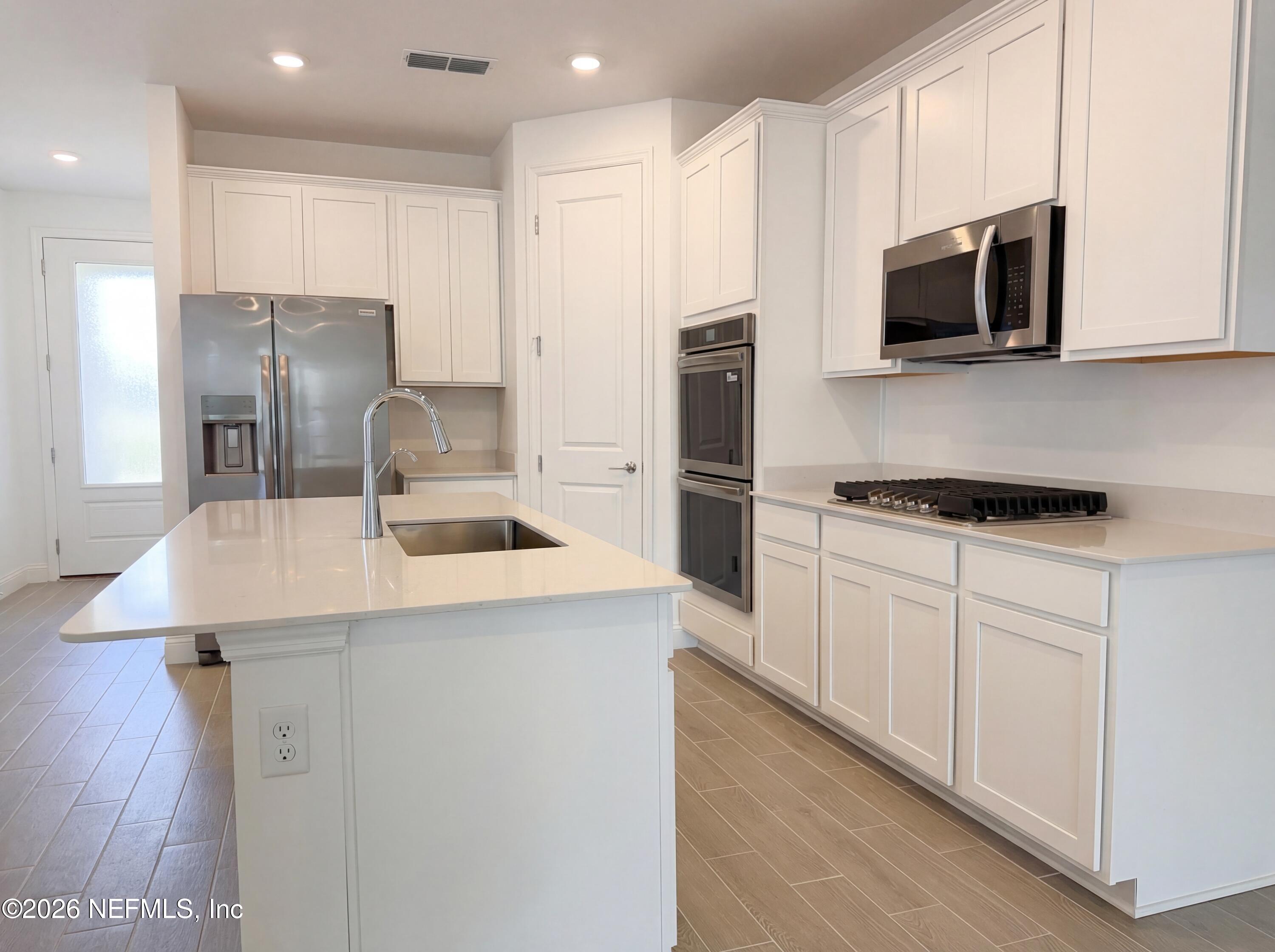 88 Round Robin St. Johns, FL 32259 - Photo 15 of 25 a kitchen with stainless steel appliances a refrigerator stove microwave and sink