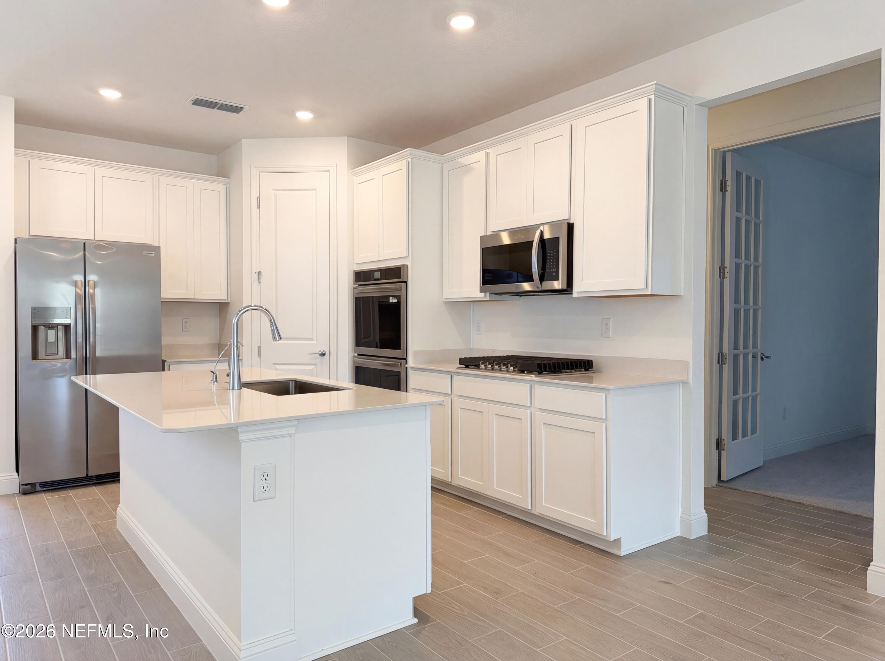 88 Round Robin St. Johns, FL 32259 - Photo 2 of 25 a kitchen with stainless steel appliances a stove refrigerator sink and microwave
