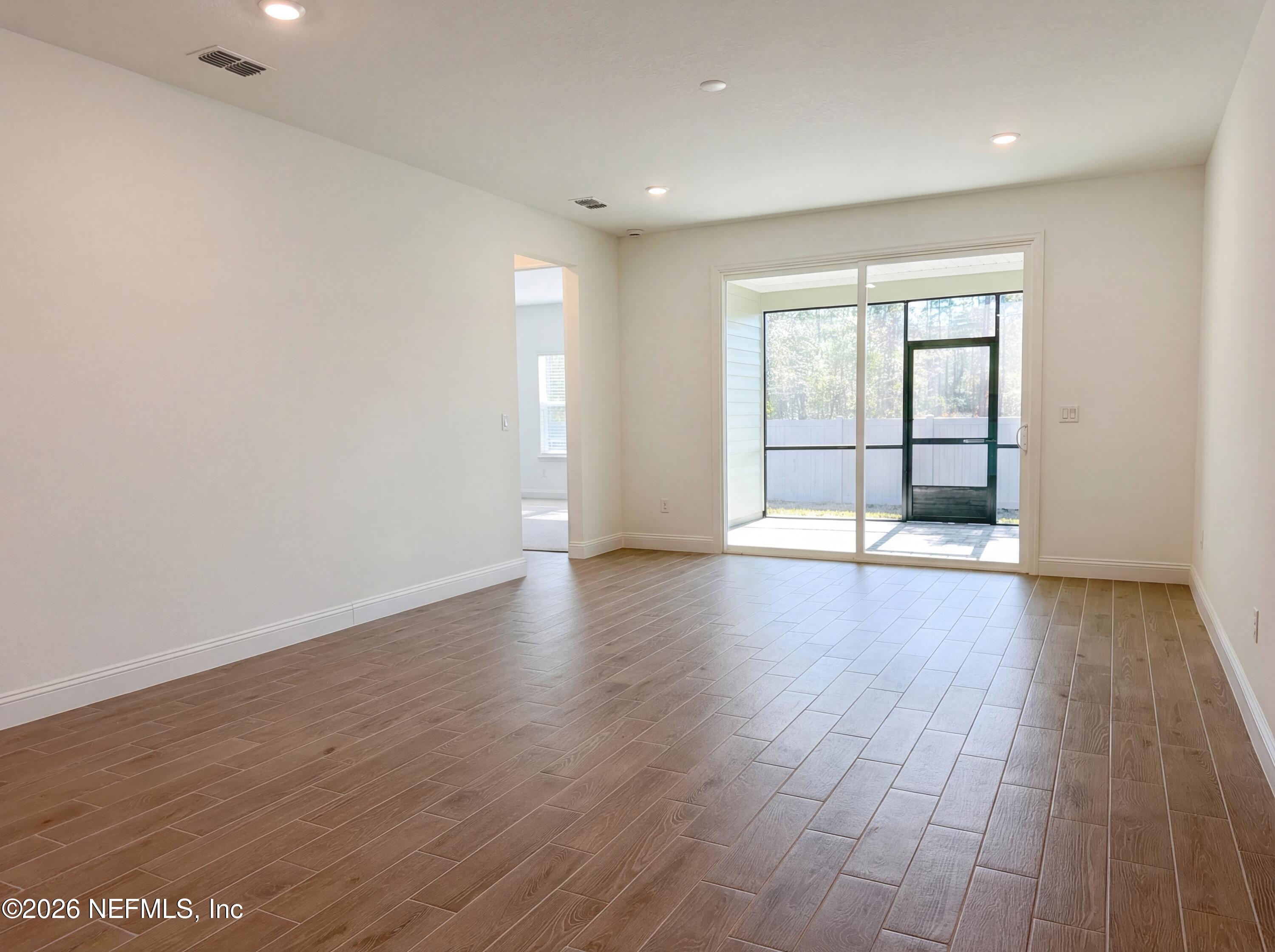 88 Round Robin St. Johns, FL 32259 - Photo 3 of 25 an empty room with wooden floor and windows