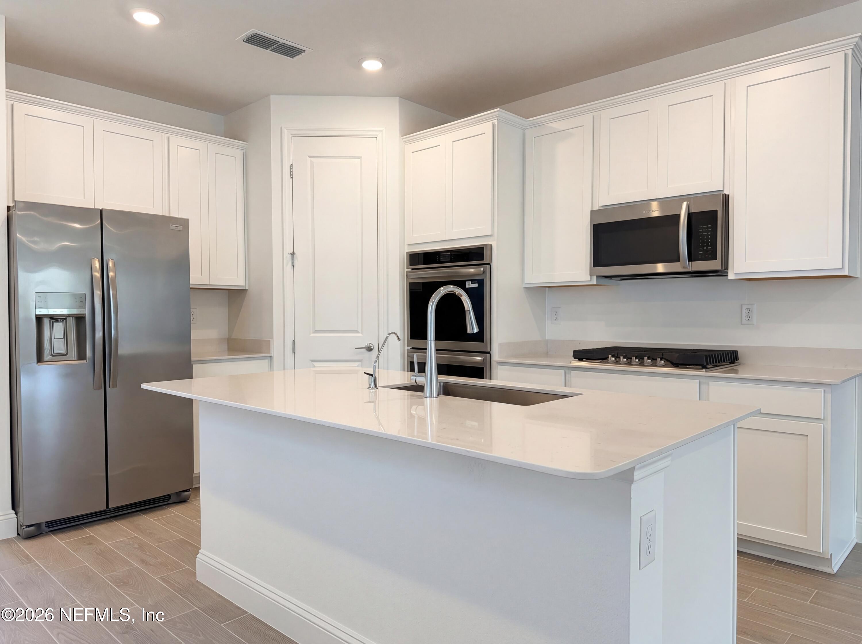 88 Round Robin St. Johns, FL 32259 - Photo 7 of 25 a kitchen with stainless steel appliances granite countertop a stove a sink and a microwave