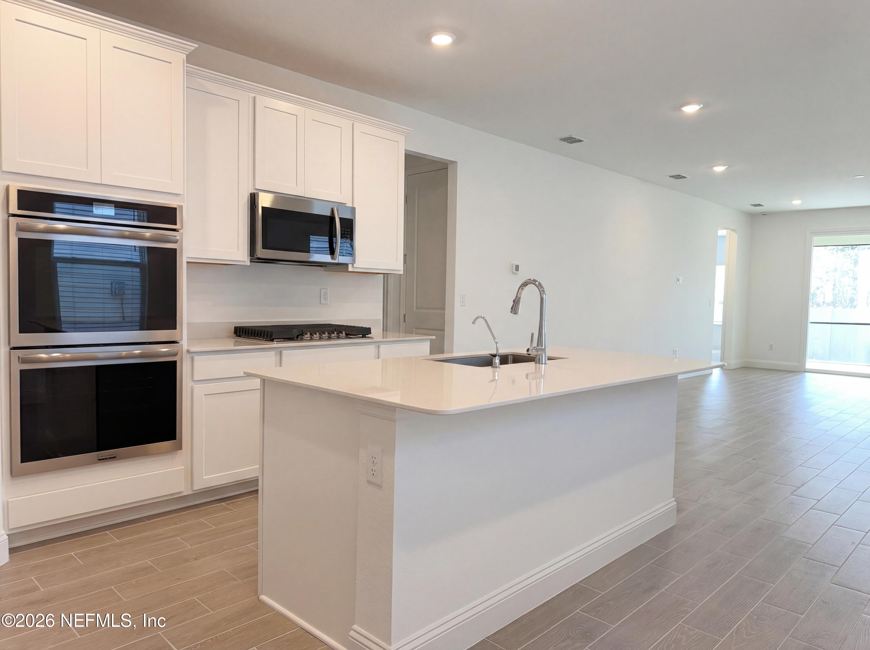 88 Round Robin St. Johns, FL 32259 - Photo 8 of 25 a kitchen with stainless steel appliances a sink stove and microwave