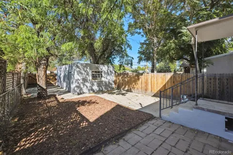 a view of a park with iron fence