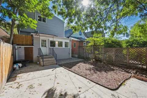 a view of a house with backyard and sitting area