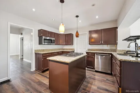 a kitchen with stainless steel appliances granite countertop a stove and a sink