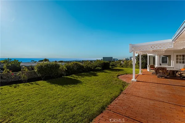 a view of a patio with dining table and chairs with a swimming pool