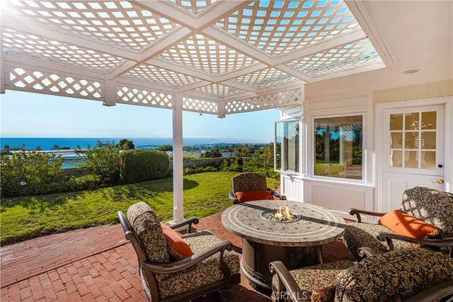 a view of a patio with couches table and chairs and potted plants