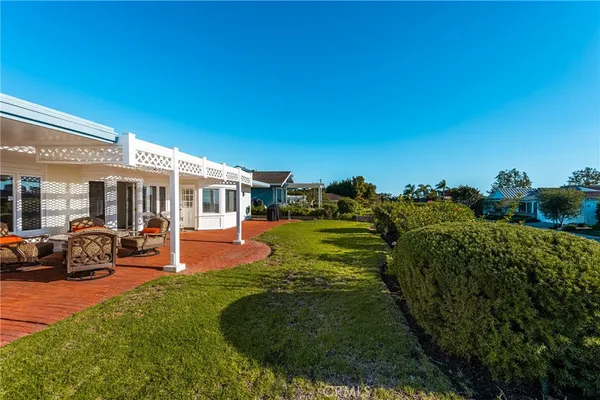 a view of a house with backyard porch and sitting area