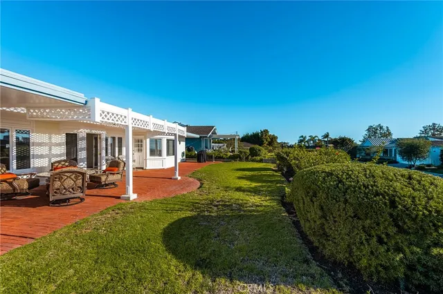 a view of a house with backyard porch and sitting area