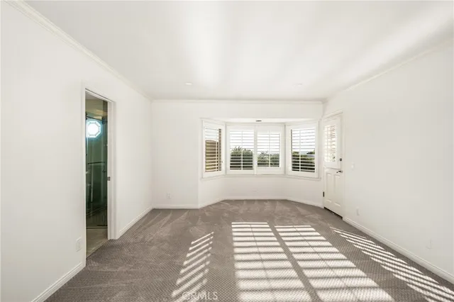 a view of a bedroom with wooden floor and windows