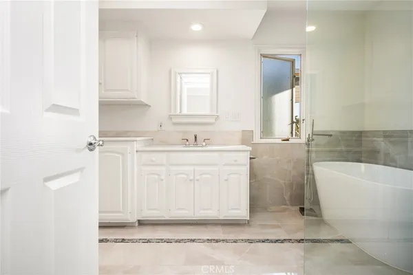 a bathroom with a sink a vanity and a mirror