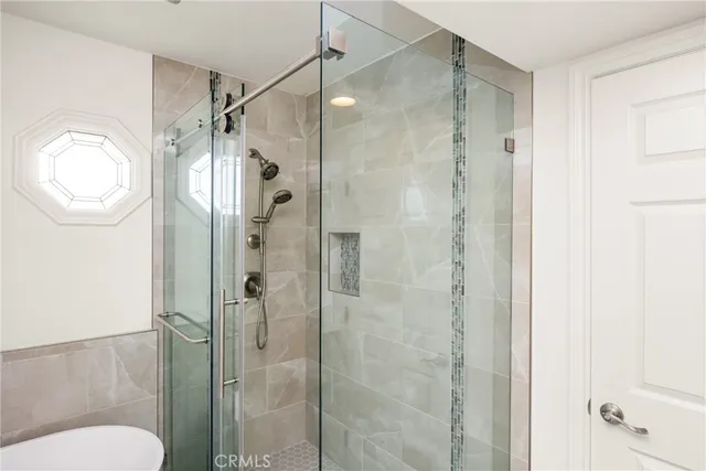 a bathroom with a shower a toilet and a sink