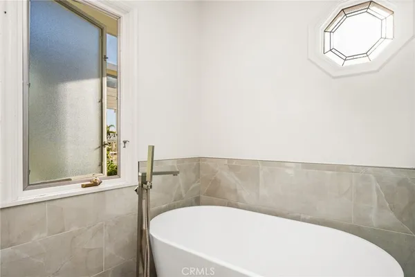 a bathroom with a bathtub and shower