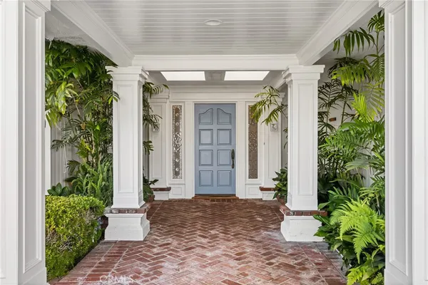a front view of a house with a blue gate