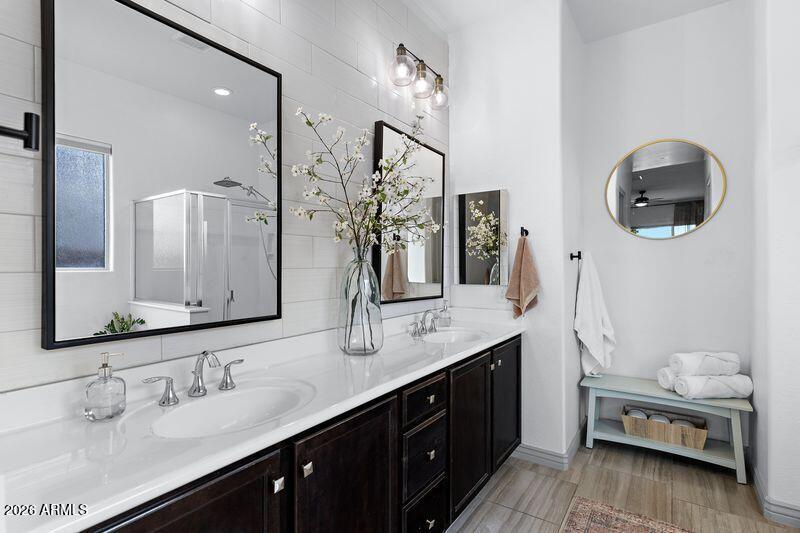 7871 South Stuart Avenue Gilbert, AZ 85298 - Photo 32 of 77 a bathroom with a double vanity sink and a mirror