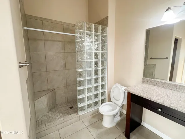 a bathroom with a toilet a sink and shower