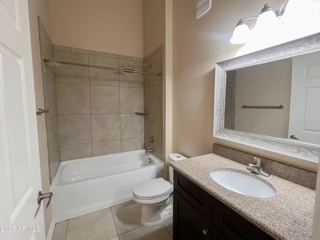 an empty room with chandelier fan