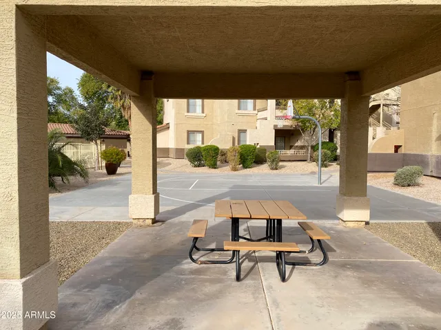a view of a patio with table and chairs
