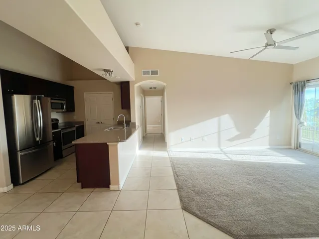 a kitchen with stainless steel appliances granite countertop a refrigerator and a sink