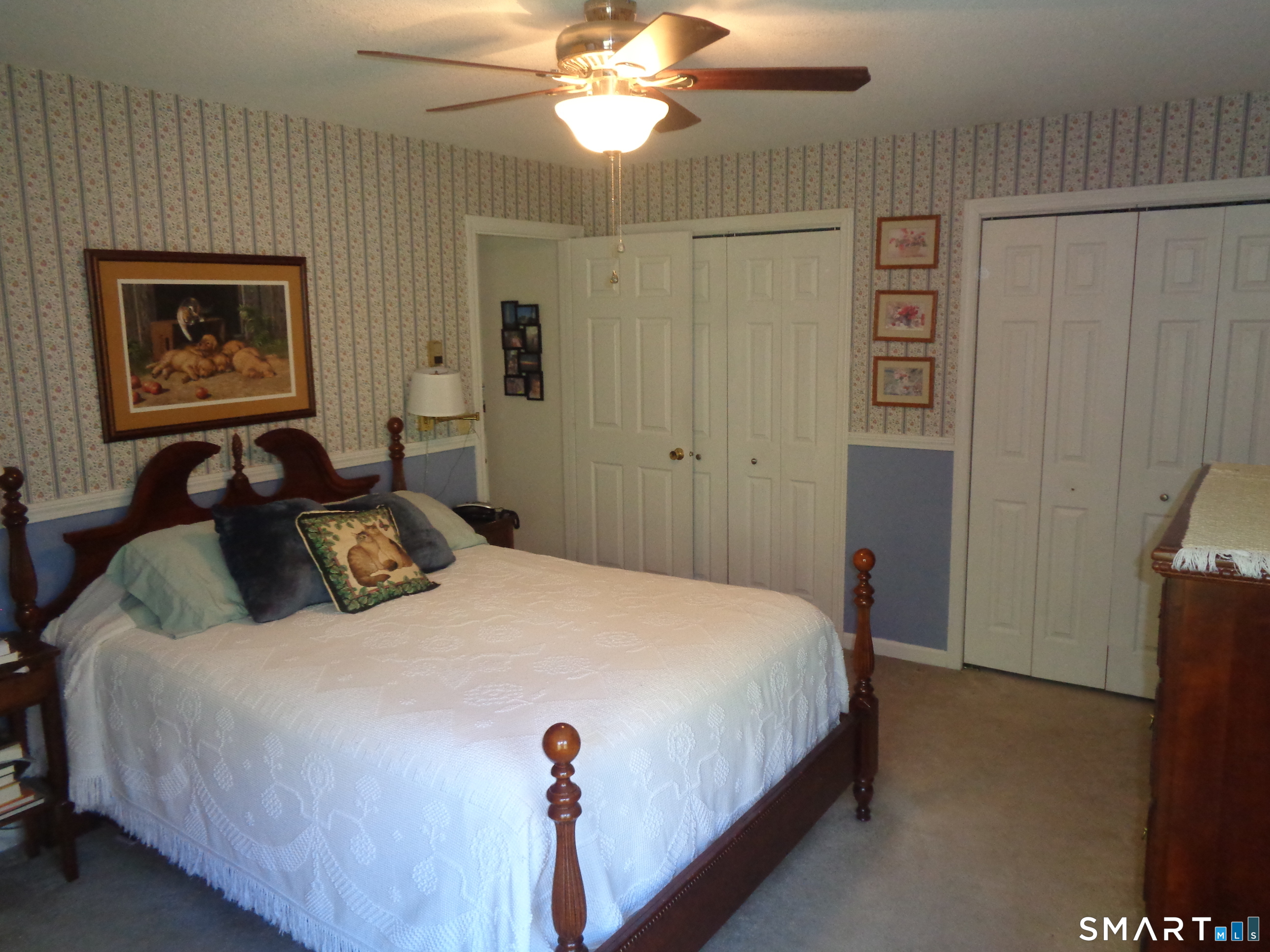 321 Spring Street Naugatuck, CT 06770 - Photo 13 of 27 a bedroom with a bed and a chandelier