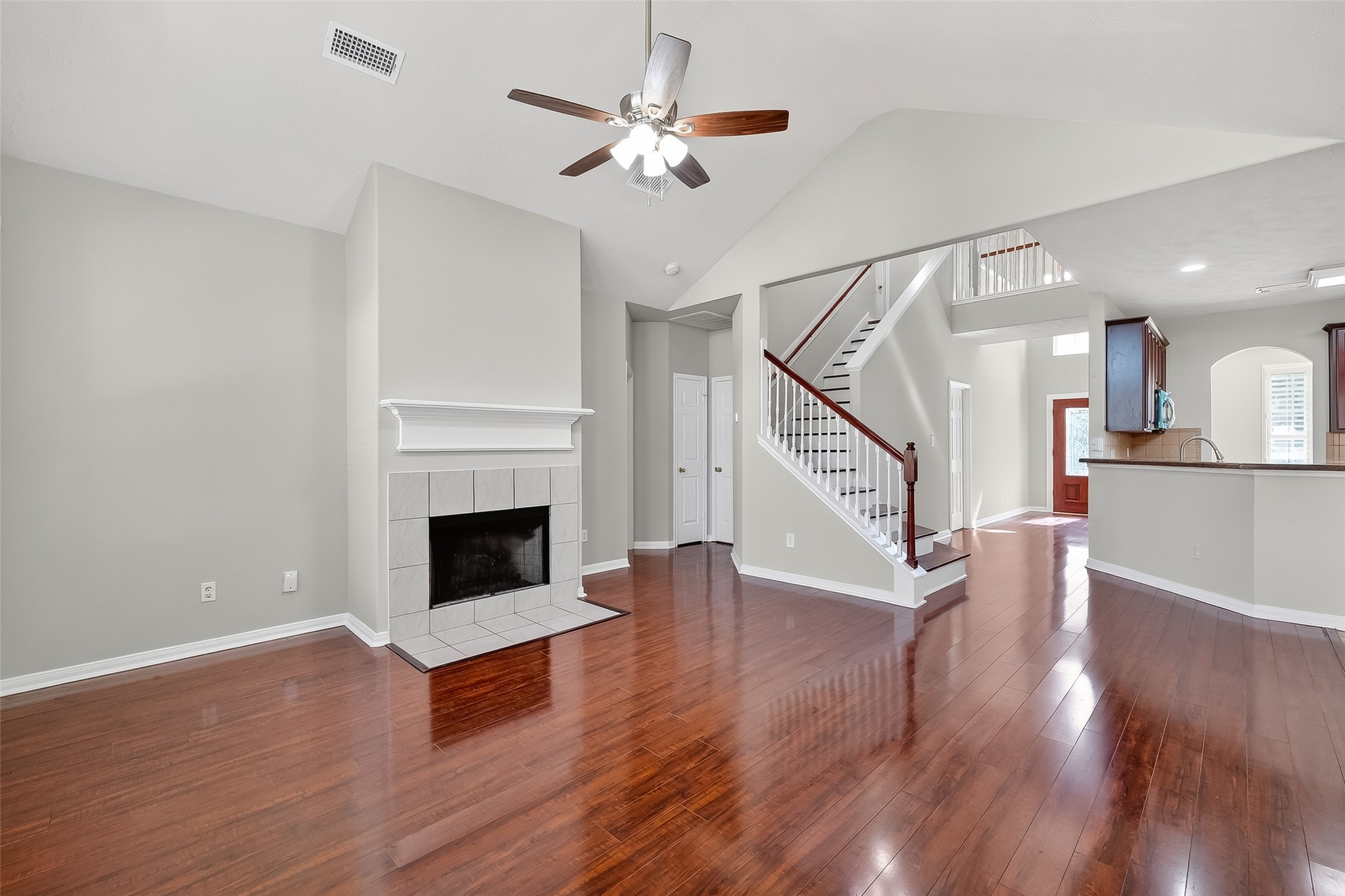6506 Rose Willow Lane Spring, TX 77379 - Photo 7 of 38 a view of a livingroom with wooden floor fireplace and a ceiling fan