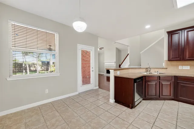 a kitchen with stainless steel appliances a stove a sink and a refrigerator