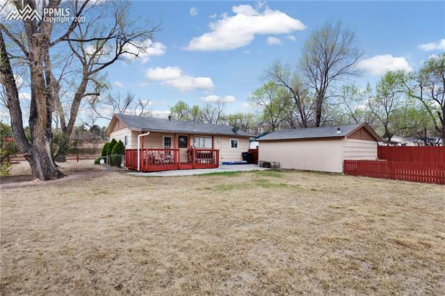 1140 Harrison Road Colorado Springs, CO 80905 - Photo 18 of 19 Back yard, view of back of home and covered deck