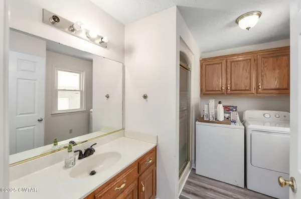 a bathroom with a sink vanity and a mirror