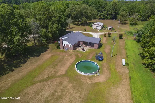 an aerial view of a house with a swimming pool