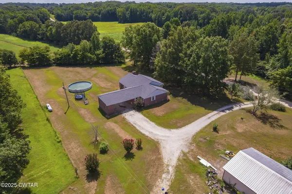 an aerial view of a houses with yard