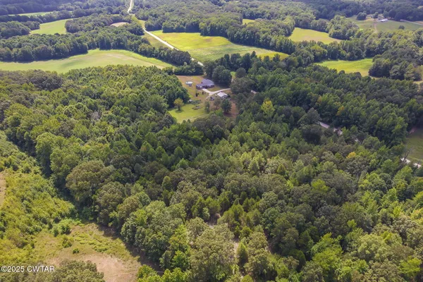 an aerial view of a houses with a yard