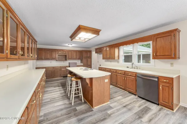 a kitchen with stainless steel appliances granite countertop a stove and a wooden floors