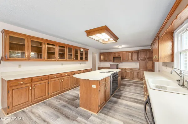 a large kitchen with stainless steel appliances granite countertop a stove and a sink