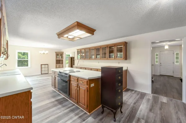 a kitchen with stainless steel appliances granite countertop a stove and a wooden floors