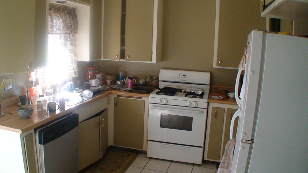 1077 Harpole Road Redding, CA 96002 - Photo 6 of 8 a kitchen with a stove and a refrigerator