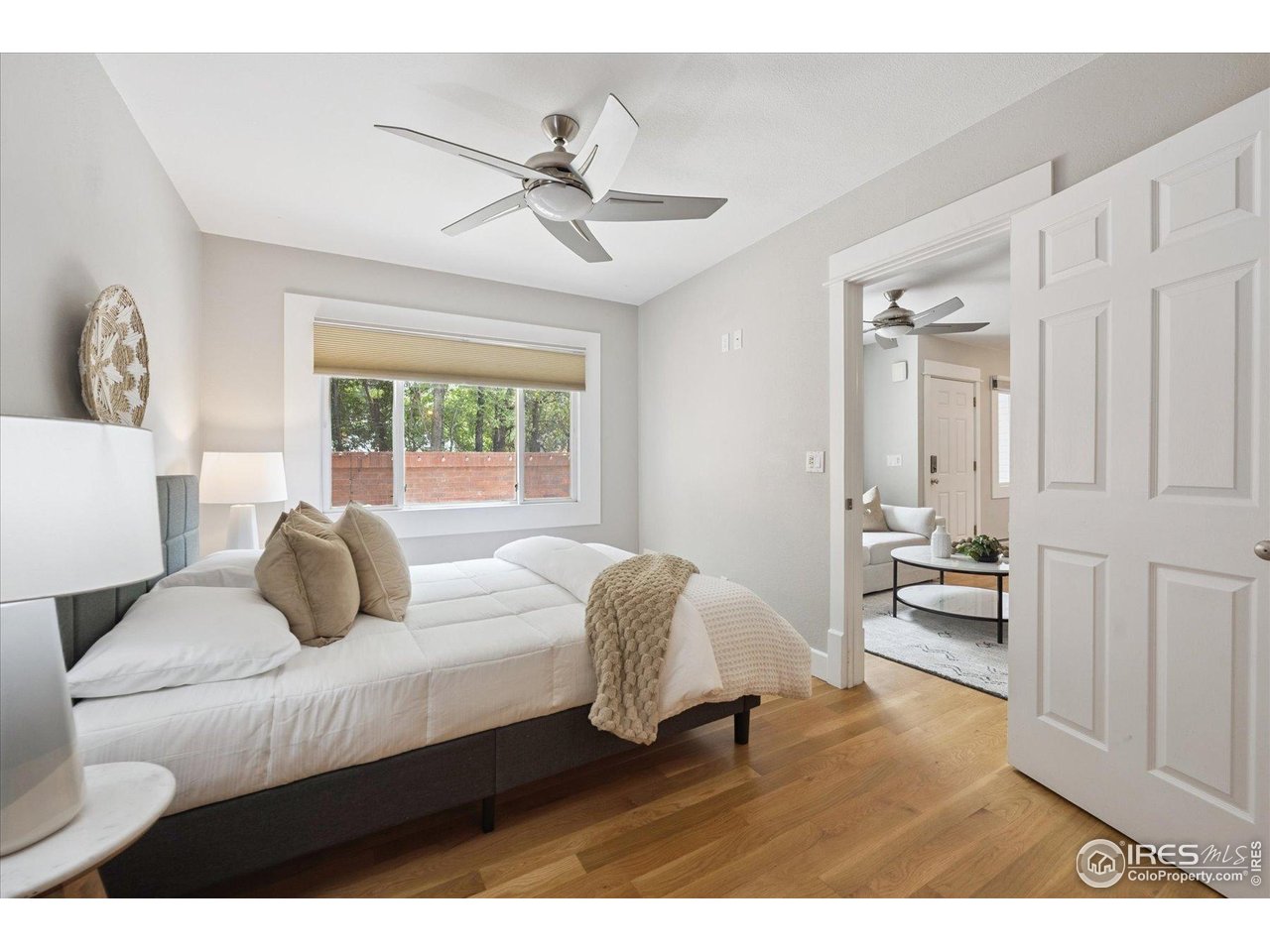 2201 Pearl Street, Unit 2 Boulder, CO 80302 - Photo 19 of 37 a bedroom with a bed and wooden floor