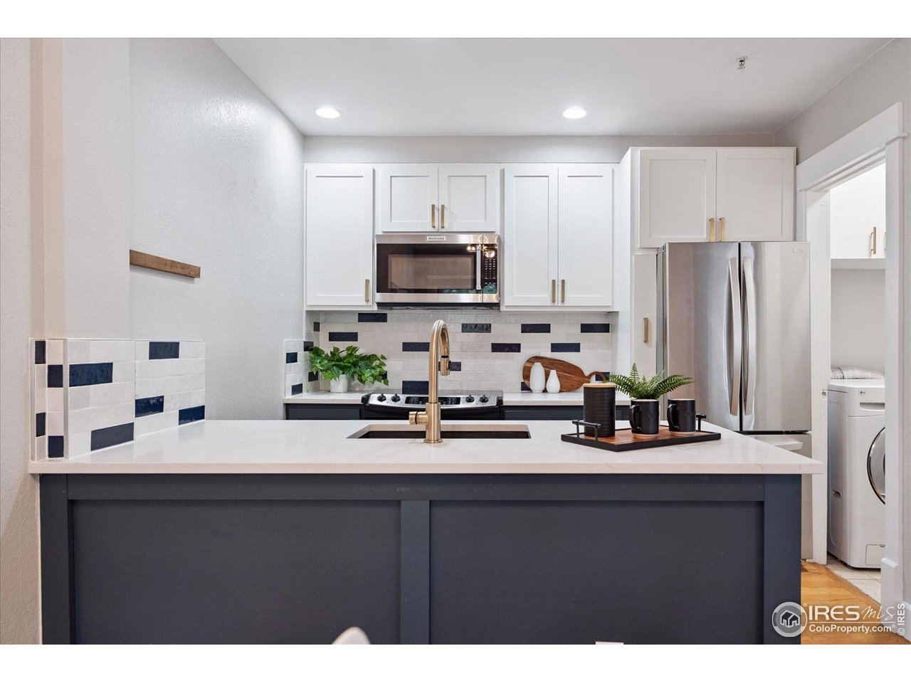 2201 Pearl Street, Unit 2 Boulder, CO 80302 - Photo 2 of 37 a kitchen with kitchen island a sink stainless steel appliances and cabinets