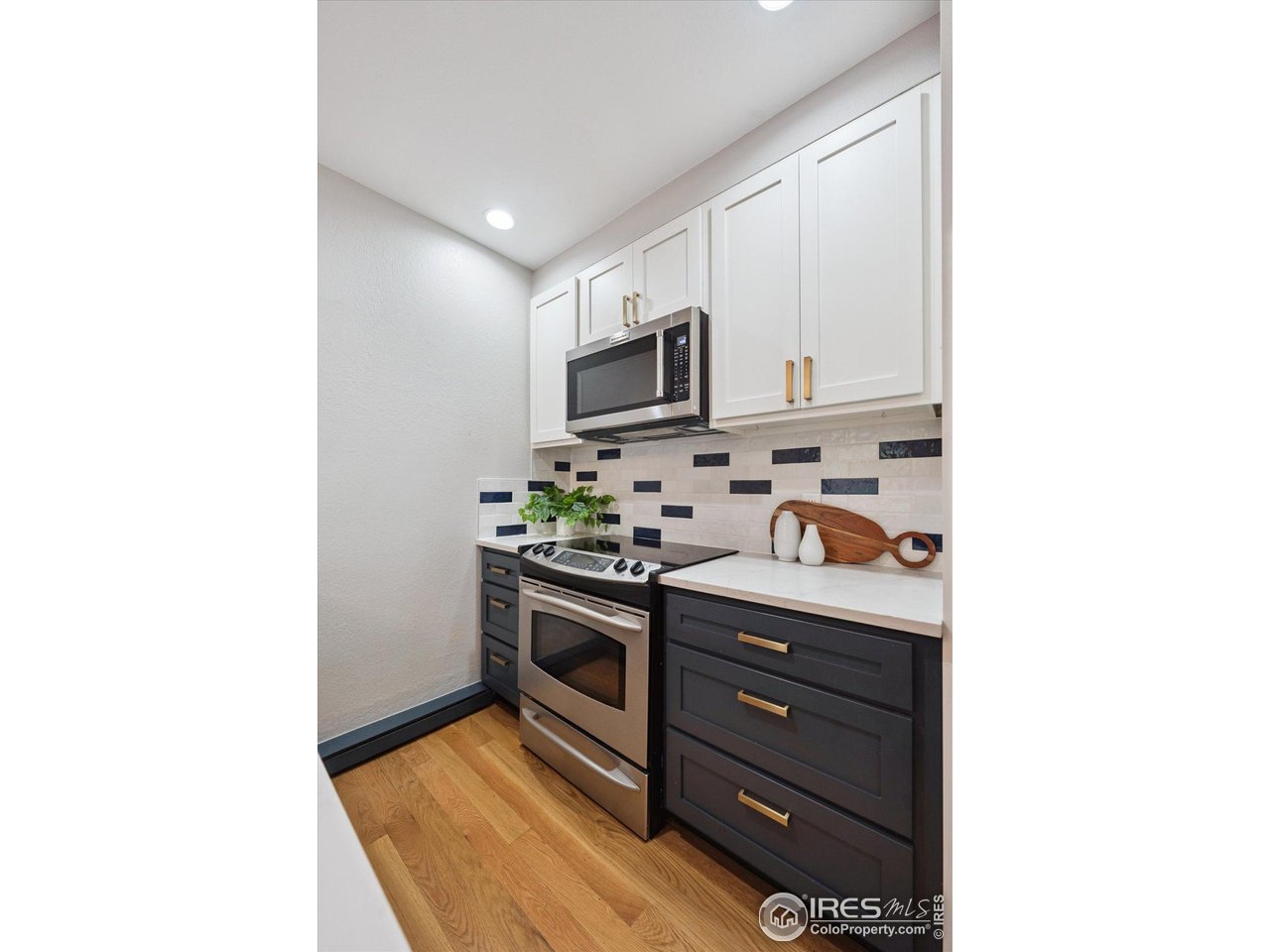 2201 Pearl Street, Unit 2 Boulder, CO 80302 - Photo 9 of 37 a kitchen with stainless steel appliances granite countertop a stove and a refrigerator