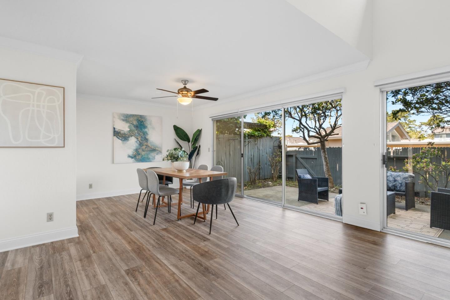 120 Paseo Ballena Aptos, CA 95003 - Photo 22 of 69 a dining room with wooden floor a chandelier a glass table and chairs
