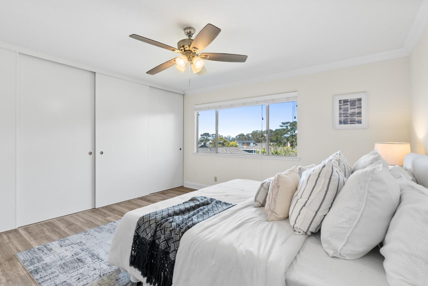 120 Paseo Ballena Aptos, CA 95003 - Photo 49 of 69 a bedroom with a large bed and a chandelier
