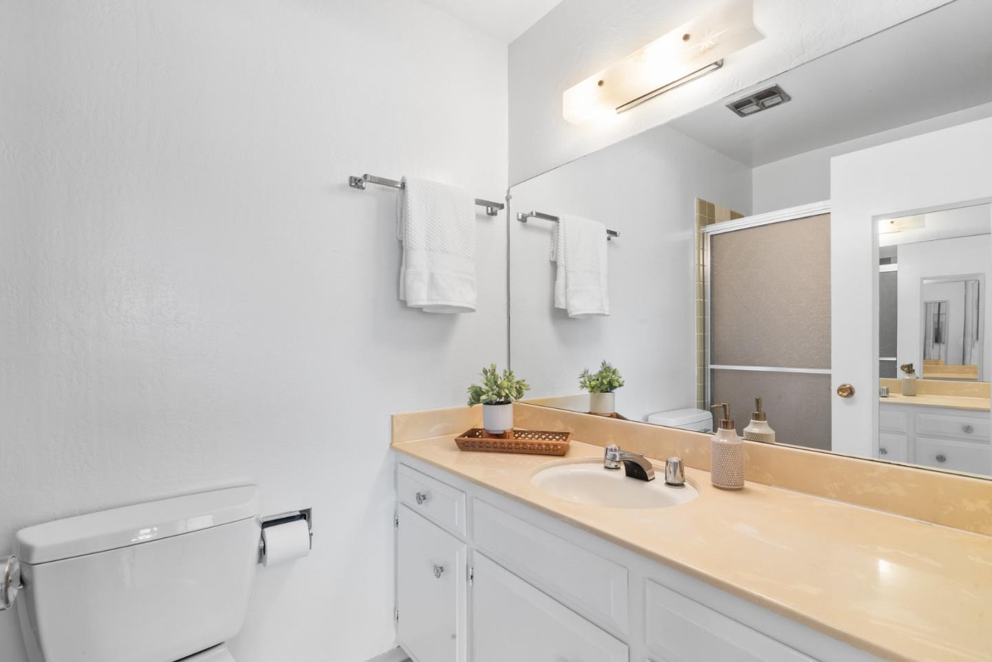 120 Paseo Ballena Aptos, CA 95003 - Photo 55 of 69 a bathroom with a sink a toilet and a large mirror
