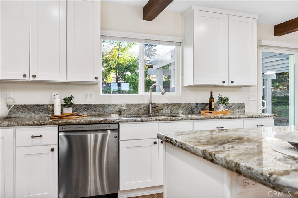 1671 Joshua Tree Lane Fallbrook, CA 92028 - Photo 12 of 44 a kitchen with granite countertop white cabinets and a sink