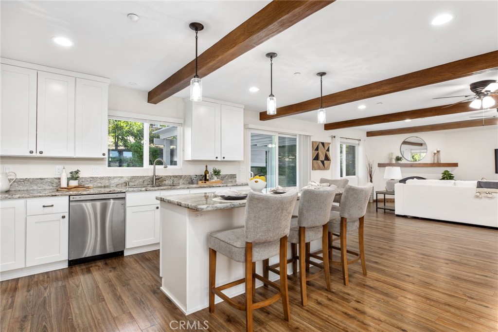 1671 Joshua Tree Lane Fallbrook, CA 92028 - Photo 13 of 44 a kitchen with stainless steel appliances granite countertop a stove a sink dishwasher and a refrigerator with wooden floor