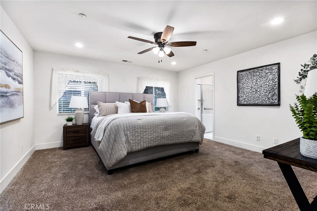 1671 Joshua Tree Lane Fallbrook, CA 92028 - Photo 22 of 44 a bedroom with a bed and a chandelier