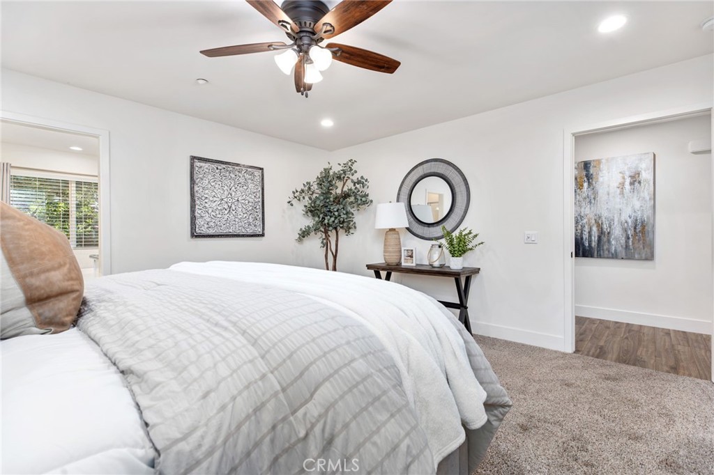 1671 Joshua Tree Lane Fallbrook, CA 92028 - Photo 23 of 44 a bedroom with a bed and a chandelier