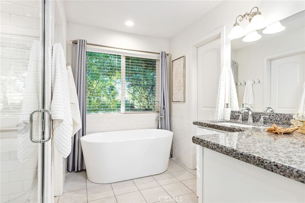 1671 Joshua Tree Lane Fallbrook, CA 92028 - Photo 24 of 44 a bathroom with a granite countertop sink and a bathtub
