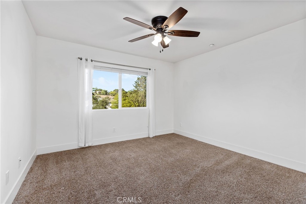 1671 Joshua Tree Lane Fallbrook, CA 92028 - Photo 27 of 44 an empty room with windows and fan