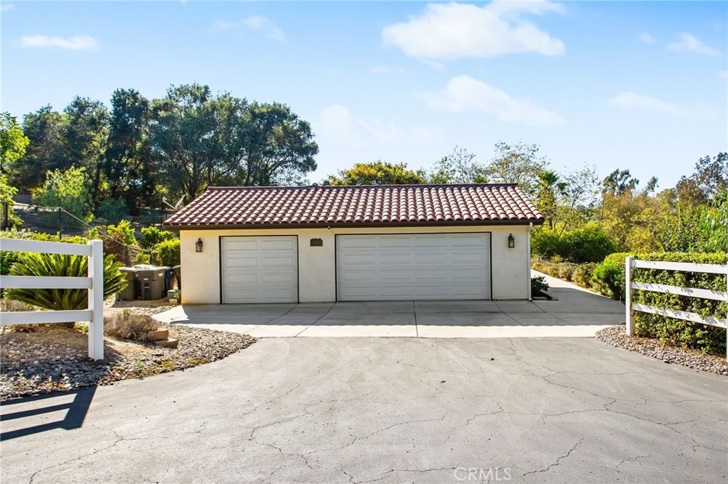 1671 Joshua Tree Lane Fallbrook, CA 92028 - Photo 36 of 44 a view of a patio with table and chairs with wooden fence