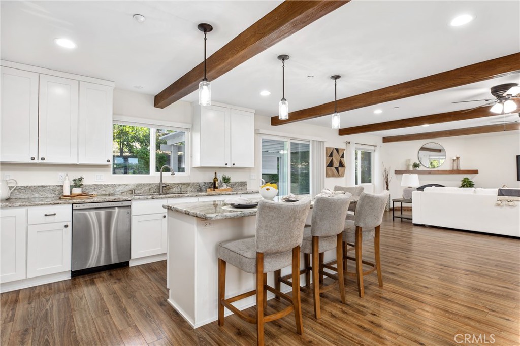 1671 Joshua Tree Lane Fallbrook, CA 92028 - Photo 4 of 44 a kitchen with stainless steel appliances granite countertop a stove a sink dishwasher and a refrigerator with wooden floor