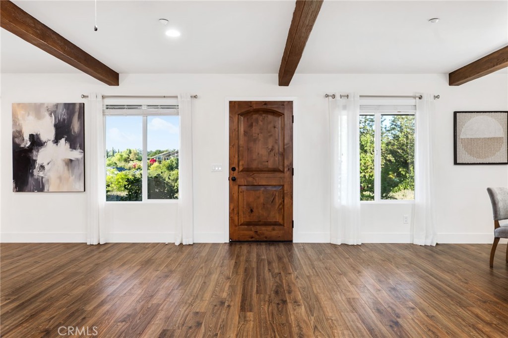 1671 Joshua Tree Lane Fallbrook, CA 92028 - Photo 9 of 44 a view of empty room with wooden floor and fan