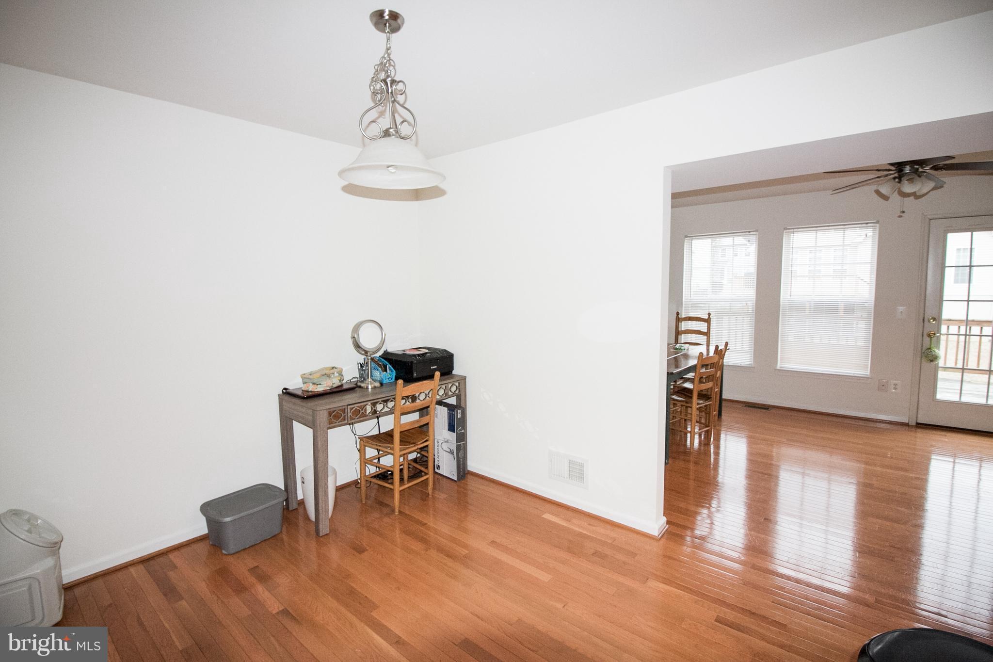 1253 Steed Street Ranson, WV 25438 - Photo 12 of 18 a view of a room with wooden floor table and chairs